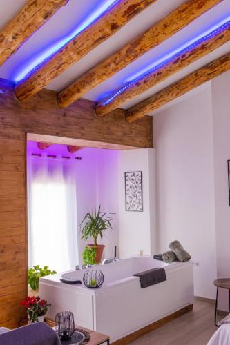a room with a white bed and blue lighting at Casa Villar in Alcalá del Júcar
