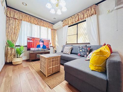 a living room with a couch and a tv at Ikebukuro Sta 8 mins Good Access Modern House TS0318 in Tokyo