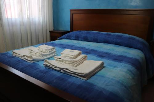 a bed with towels sitting on top of it at Casa nel Delta del Po in Scardovari
