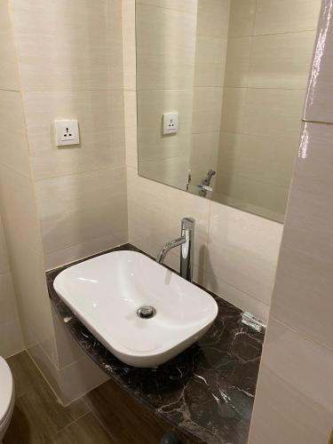 a bathroom with a sink and a mirror at MESA Thamrin City Apartments at Nagoya with Netflix & Pick Up Service in Nagoya