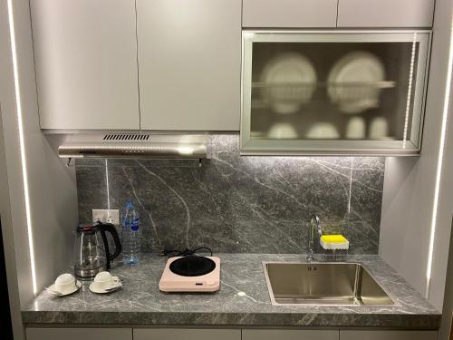 a kitchen counter with a sink and a microwave at MESA Thamrin City Apartments at Nagoya with Netflix & Pick Up Service in Nagoya