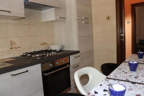 a kitchen with a stove and a counter top at Casa nel Delta del Po in Scardovari