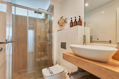 a bathroom with a sink and a shower and a toilet at Suite Deluxe Face Mer Apart Malaga in Málaga