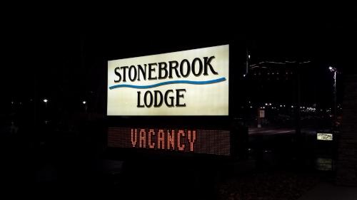 a sign for a signostoke lodge at night at Stonebrook Lodge in Cherokee