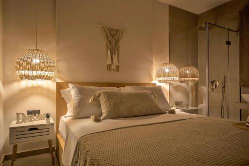 a bedroom with a large bed and two chandeliers at Cozzzy. Exclusive Apartment. in Thessaloniki
