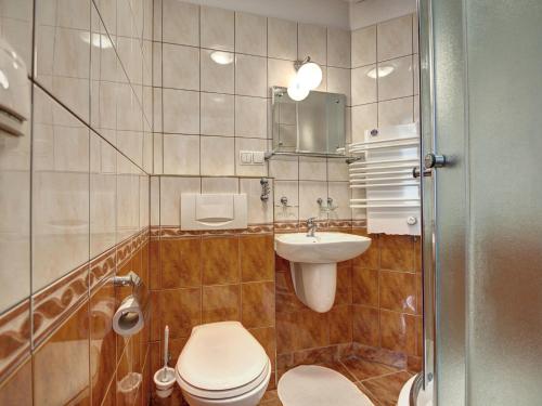 a bathroom with a toilet and a sink at Pokoje Gościnne Zbyszko in Zakopane