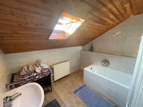 a bathroom with a sink and a bath tub at Hot-l Mini in Nagykanizsa