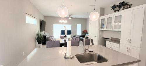 a kitchen with a sink and a living room at Bungalow Tarvana-#1 in Port Isabel