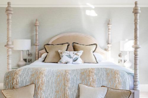 a bed with two pillows on top of it at The Greenway Hotel & Spa in Cheltenham