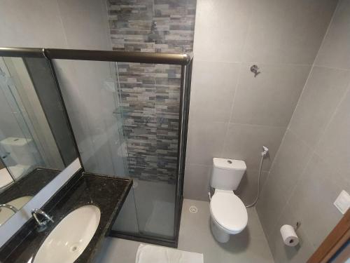 ein Bad mit einem WC, einem Waschbecken und einer Dusche in der Unterkunft Flats em Condominio Velas do Porto in Porto De Galinhas