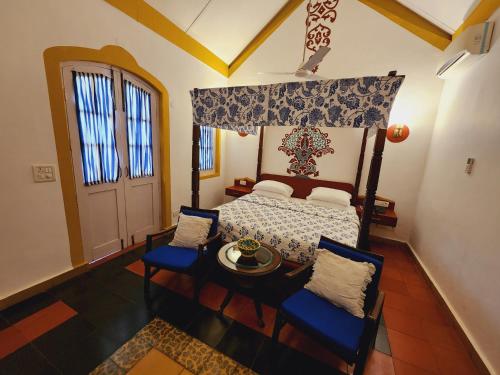 an overhead view of a bedroom with a bed and chairs at Casa Anjuna in Anjuna
