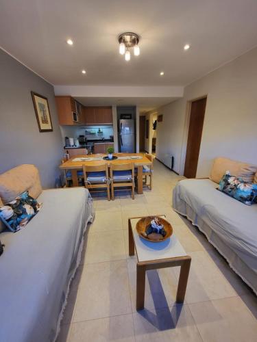 a living room with a couch and a table at Departamento en Edificio Atenas con excelentes Vistas in Las Lenas