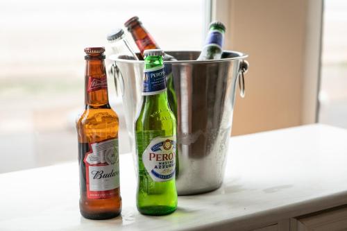 two bottles of beer sitting next to a bucket at Lyndene Hotel in Blackpool
