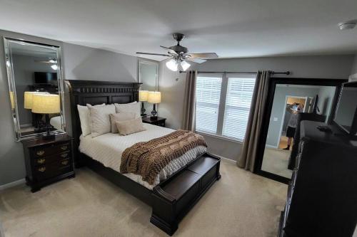 a bedroom with a large bed and a mirror at Mackintosh Townhome in Burlington