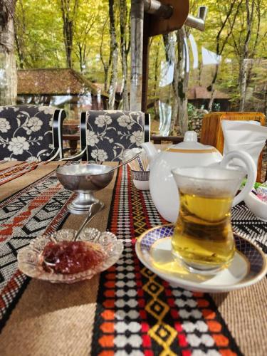 a table with a tea pot and a cup on it at Qusar Qala Hotel in Qusar