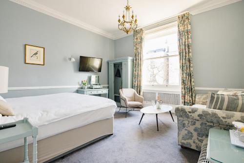 a bedroom with a bed and a living room at The Abbey Notting Hill in London