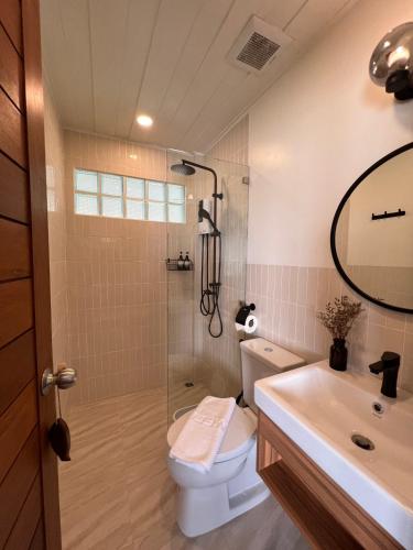 a bathroom with a shower and a toilet and a sink at Boon Heritage House Koh Samui in Koh Samui 