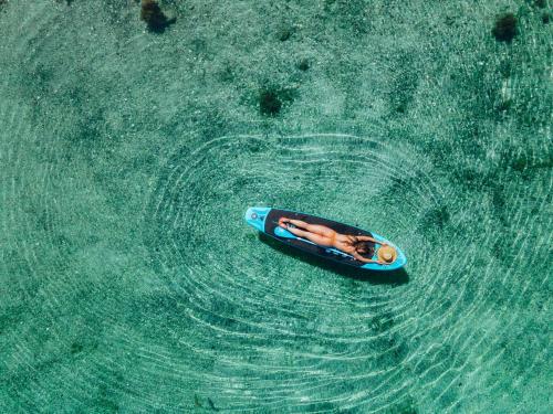 a person laying in a kayak in the water at Floating Villa Bergen in Bergen