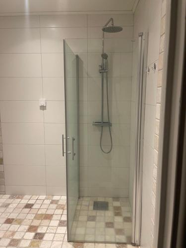 a shower with a glass door in a bathroom at Utterbyn/Sirsjön 