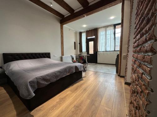 a bedroom with a bed and a brick wall at Apartment #5 Old Tbilisi in Tbilisi City