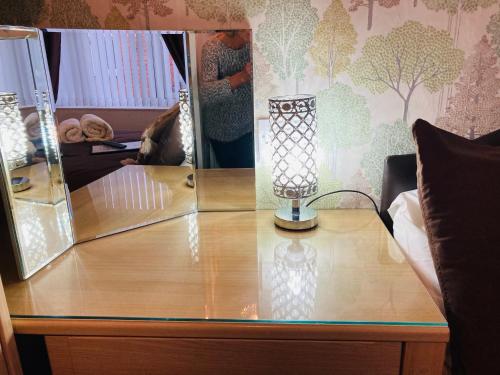 a table with a lamp on top of it at Fairfax in Skegness