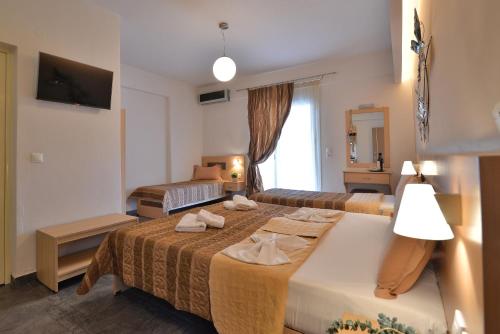 Cama o camas de una habitación en Aigli Rooms