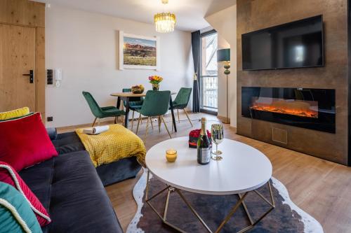 a living room with a couch and a table at Rezydencja Strążyska & Chalet BBQ in Zakopane