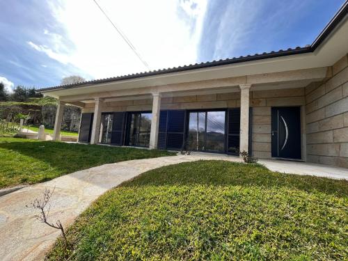 a house with a walkway in front of it at Casa da Falperra in Arcos de Valdevez