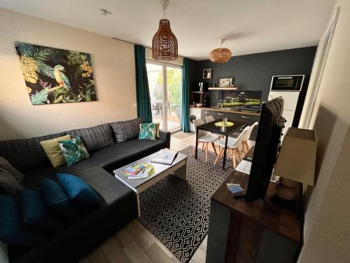 un salon avec un canapé et une table dans l'établissement Lodge spa privatif Sylvestre, séjour zen, à Meisenthal