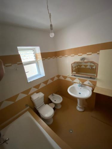 La salle de bains est pourvue de toilettes et d'un lavabo. dans l'établissement Elti Apartment, à Saranda
