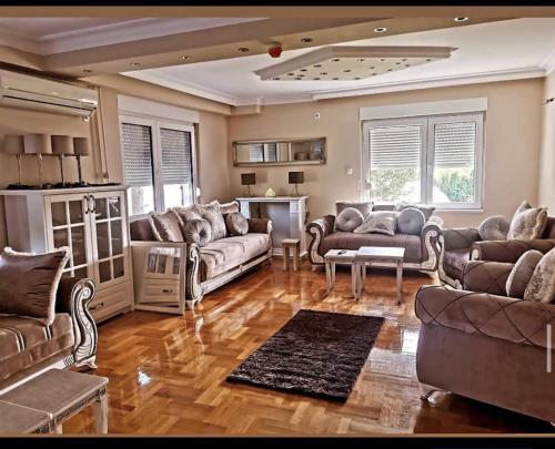 a large living room with couches and a table at Vila Jovanovic in Barajevo