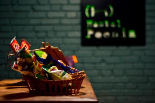 a basket of candy sitting on a table at Hostel Poesia in Foz do Iguaçu