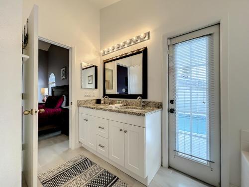 a bathroom with a sink and a mirror at Gorgeous Pool Home Near Disney - 2024 specials! in Davenport
