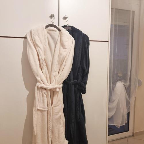 a robe hanging on a rack in a room at In Centre Suite by Open City in Tripoli