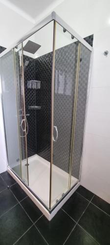 a shower with a glass enclosure in a bathroom at Modern & Cosy Apartment in Fundão Centre in Fundão