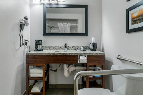a bathroom with a sink and a mirror at Comfort Inn East Oregon - Toledo in Oregon