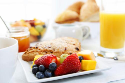 a plate of food with fruit on a table at Omni Royal Orleans Hotel in New Orleans