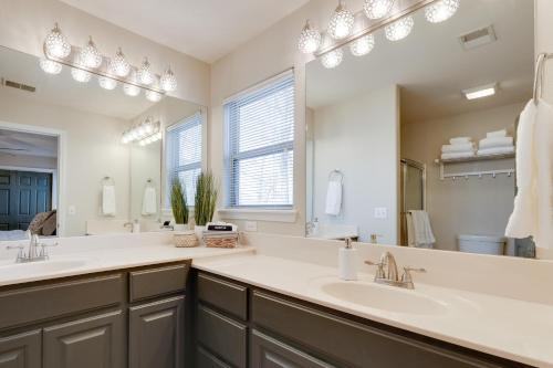 a bathroom with two sinks and a large mirror at Branson West Retreat - 2 Mi to Silver Dollar City! in Branson West