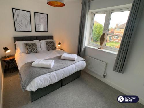 a bedroom with a bed with two pillows on it at High Wycombe - 2 Bedroom House in Buckinghamshire