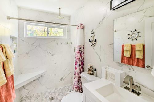 a white bathroom with a sink and a toilet at Cozy Monterey Apartment - Walk to Wharf and Dtwn! in Monterey