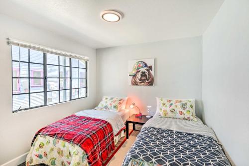 two beds in a room with a window at Cozy Monterey Apartment - Walk to Wharf and Dtwn! in Monterey