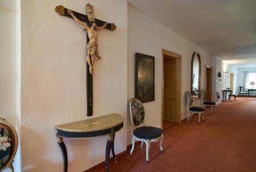 a cross hanging on a wall next to a hallway at Appartements Greier in Telfes im Stubai