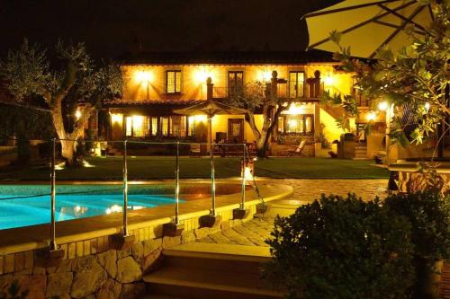 a house with a swimming pool at night at Cosy penthouse loft with stunning view in Rome