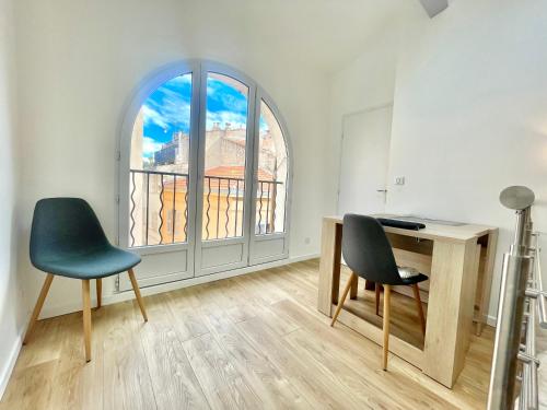 Cette chambre dispose d'un bureau, de deux chaises et d'une fenêtre. dans l'établissement New loft 2 bedroom flat cannes croisette / Palais des festivals, à Cannes