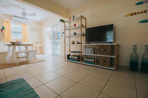 a living room with a television and a tiled floor at Dushi Villa in Palm-Eagle Beach