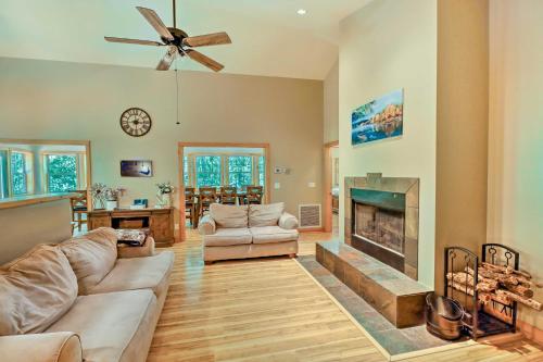 a living room with a couch and a fireplace at Lakefront Family Escape with Fire Pit and 2 Decks! in Heber Springs