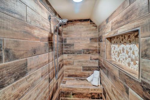 a walk in shower with wood paneled walls at Lakefront Family Escape with Fire Pit and 2 Decks! in Heber Springs