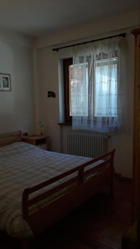 Un dormitorio con una cama grande y una ventana en Casa di Giulia en Champoluc