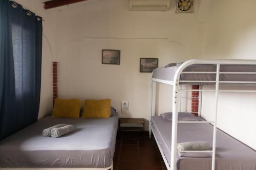 a room with two bunk beds in a room at The Corner Hostel in Playa Blanca