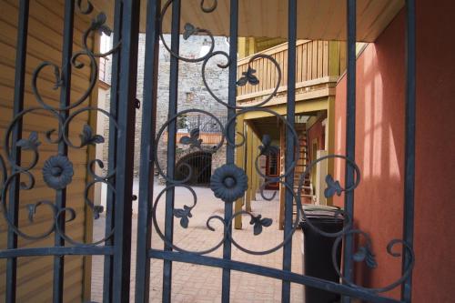 a view through an iron gate into a courtyard at Haapsalu Old Town Apartment in Haapsalu
